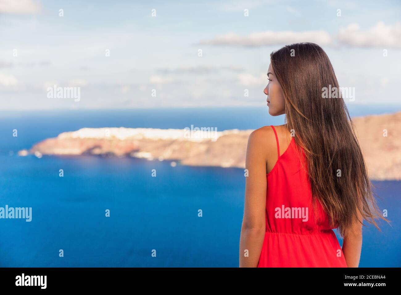 Santorini greece travel luxury destination Asian woman beauty at Oia landscape background. Tourist girl on holiday. Stock Photo