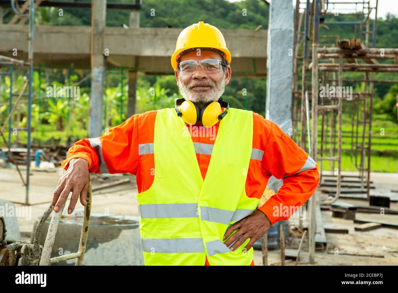 Asian senior worker engineer wearing helmet and safety clothes in the house  construction site. Working elderly people concept Stock Photo - Alamy