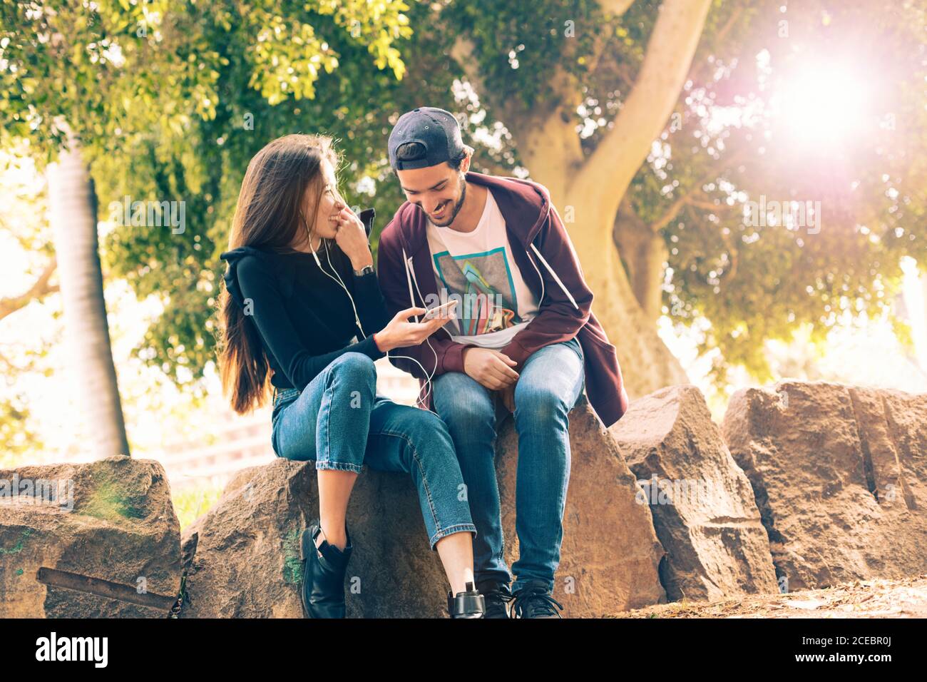 Couple with smartphone in park Stock Photo