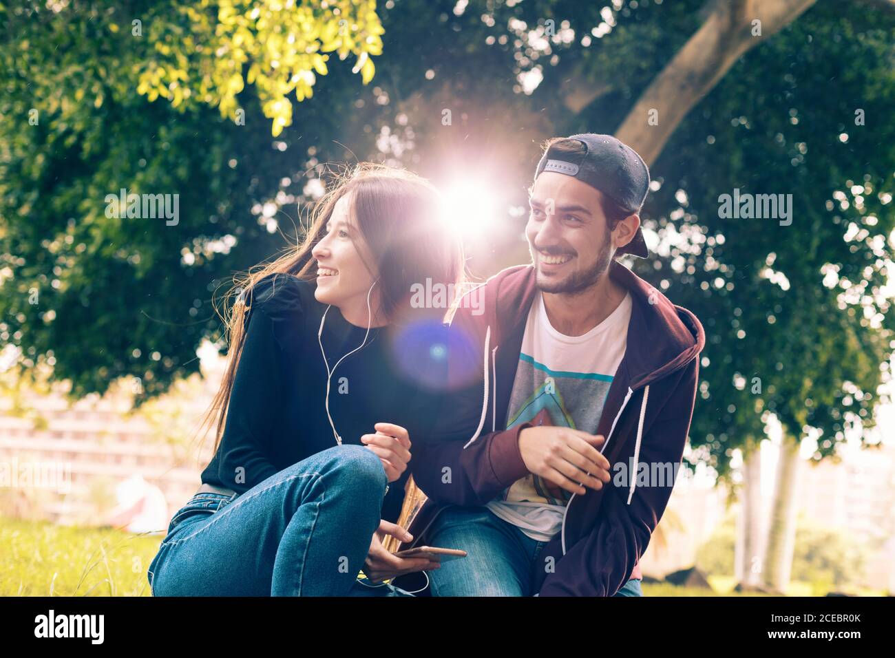 Couple with smartphone in park Stock Photo