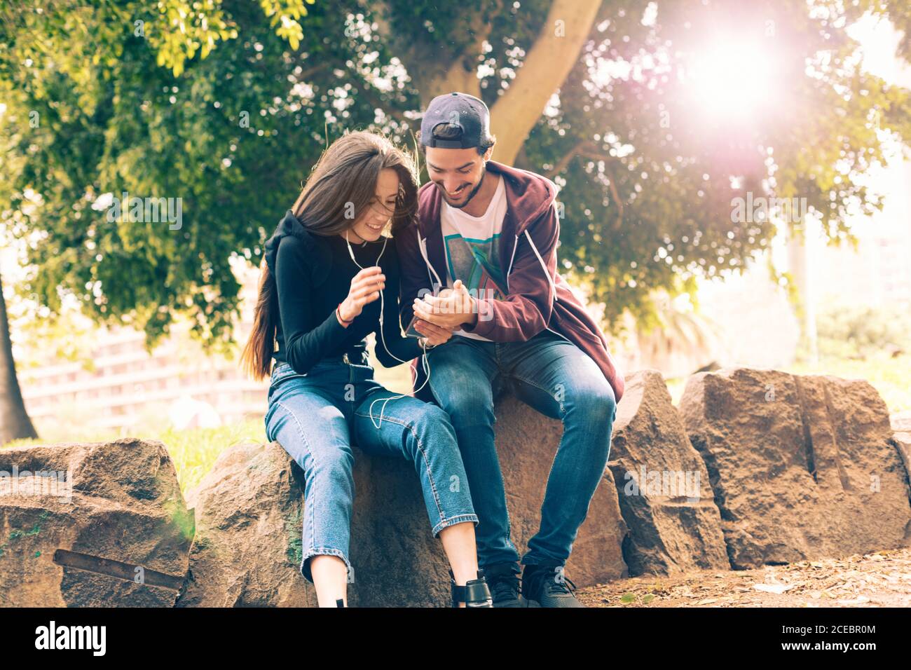 Couple with smartphone in park Stock Photo