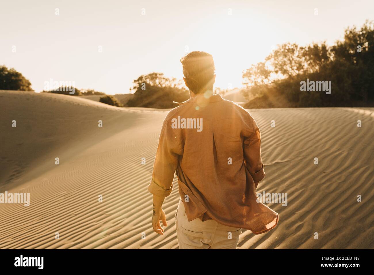 man walking on sand dunes Stock Photo Alamy
