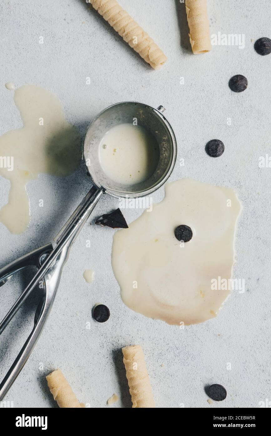 Melted vanilla ice cream in a silver spoon Stock Photo Alamy