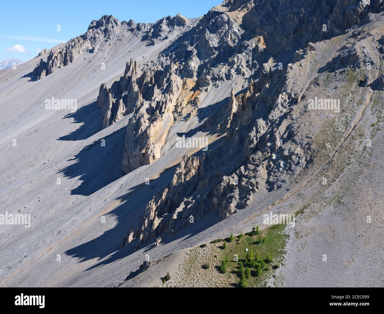 AERIAL VIEW. Barren landscape of eroded pinnacles and a large slope of scree. La Casse Déserte, Col Izoard, Arvieux, Hautes-Alpes, France. Stock Photo