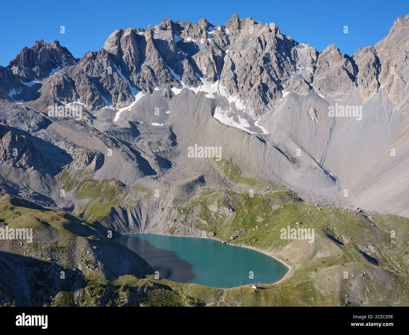AERIAL VIEW. Lac Sainte-Anne, a glacial lake (alt: 2414m) at the foot of  pics de la Font Sancte (alt: 3385m). Ceillac, Hautes-Alpes, France. Stock Photo