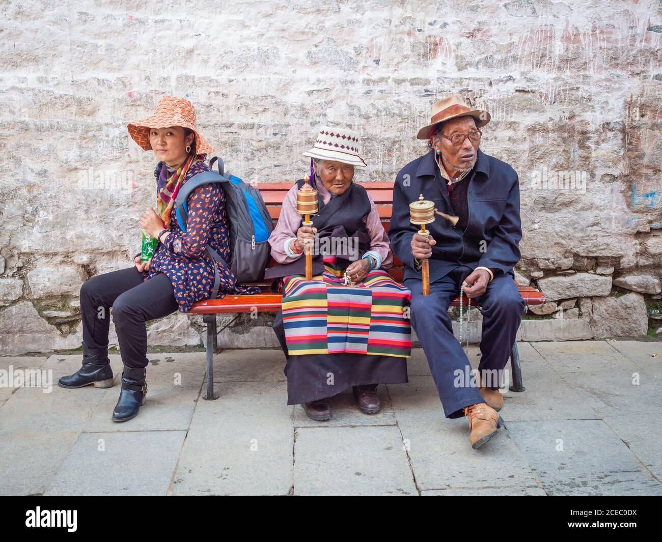Tibet - August, 29 2014: Ethnic people sitting on street bench Stock Photo