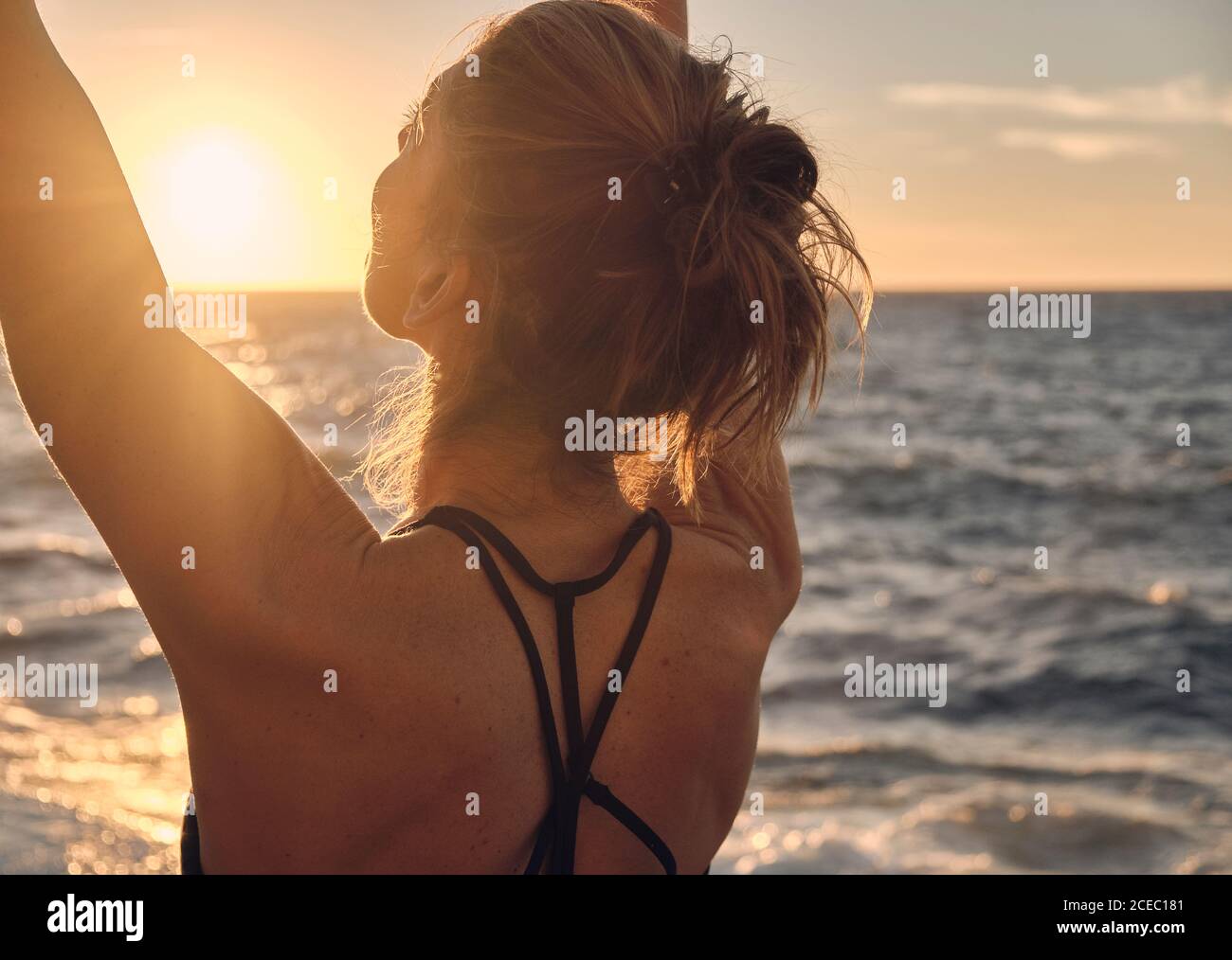 Young Woman doing yoga during sundown Stock Photo