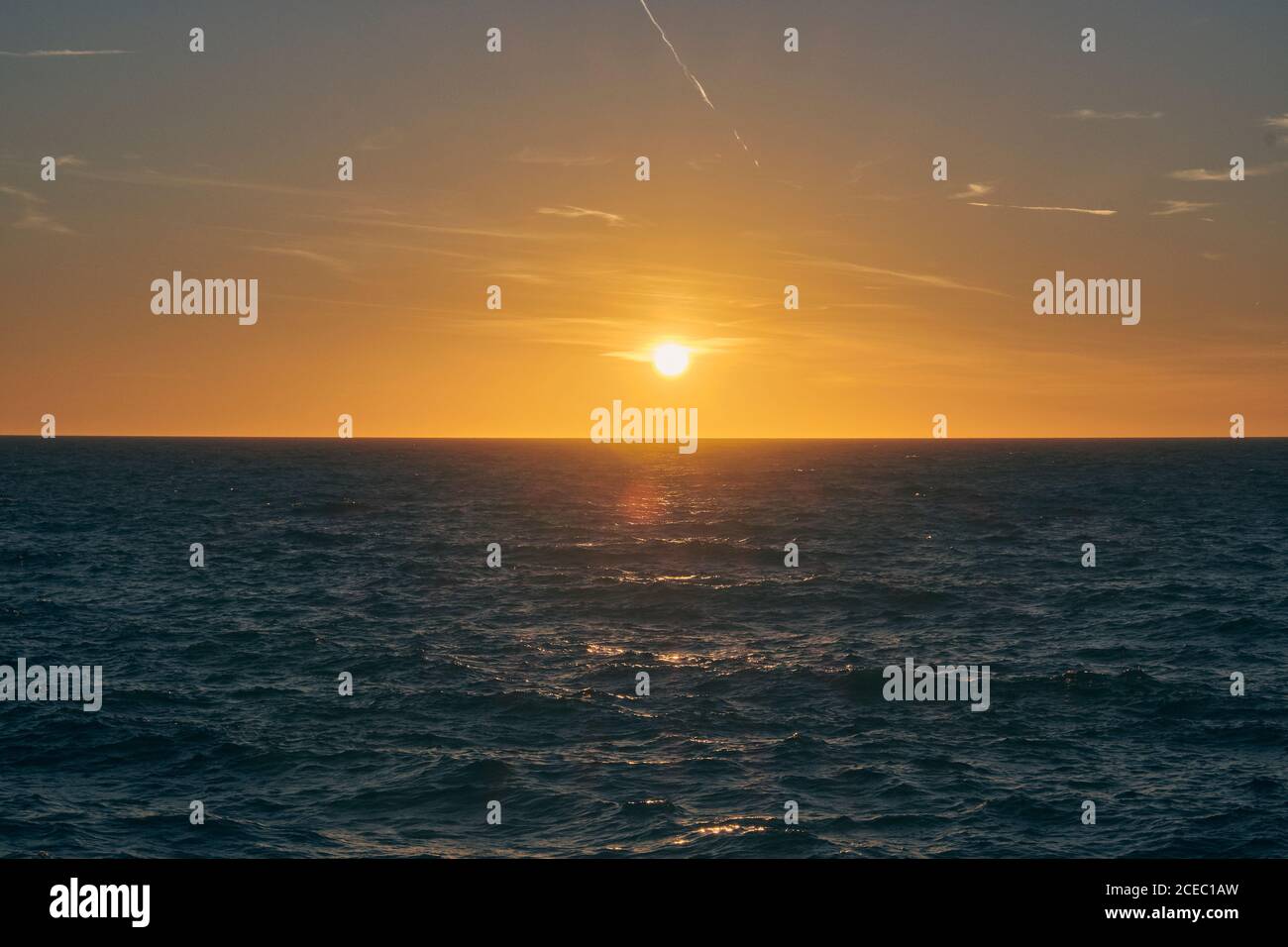 Setting sun over sea waves hi-res stock photography and images - Alamy