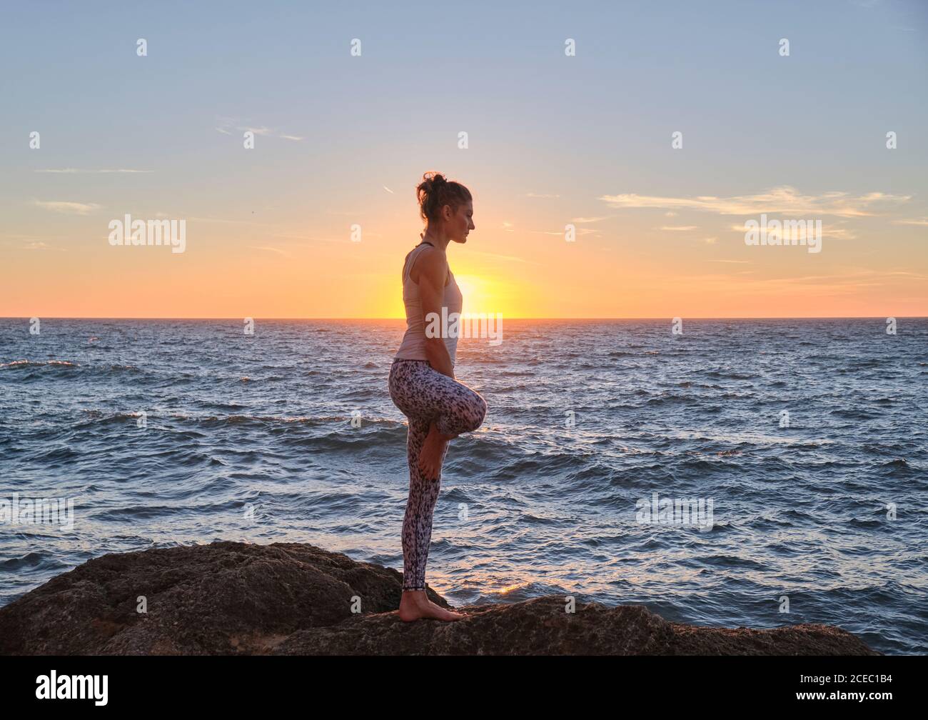 Anonymous strong shirtless male athlete balancing on gymnastic rings
