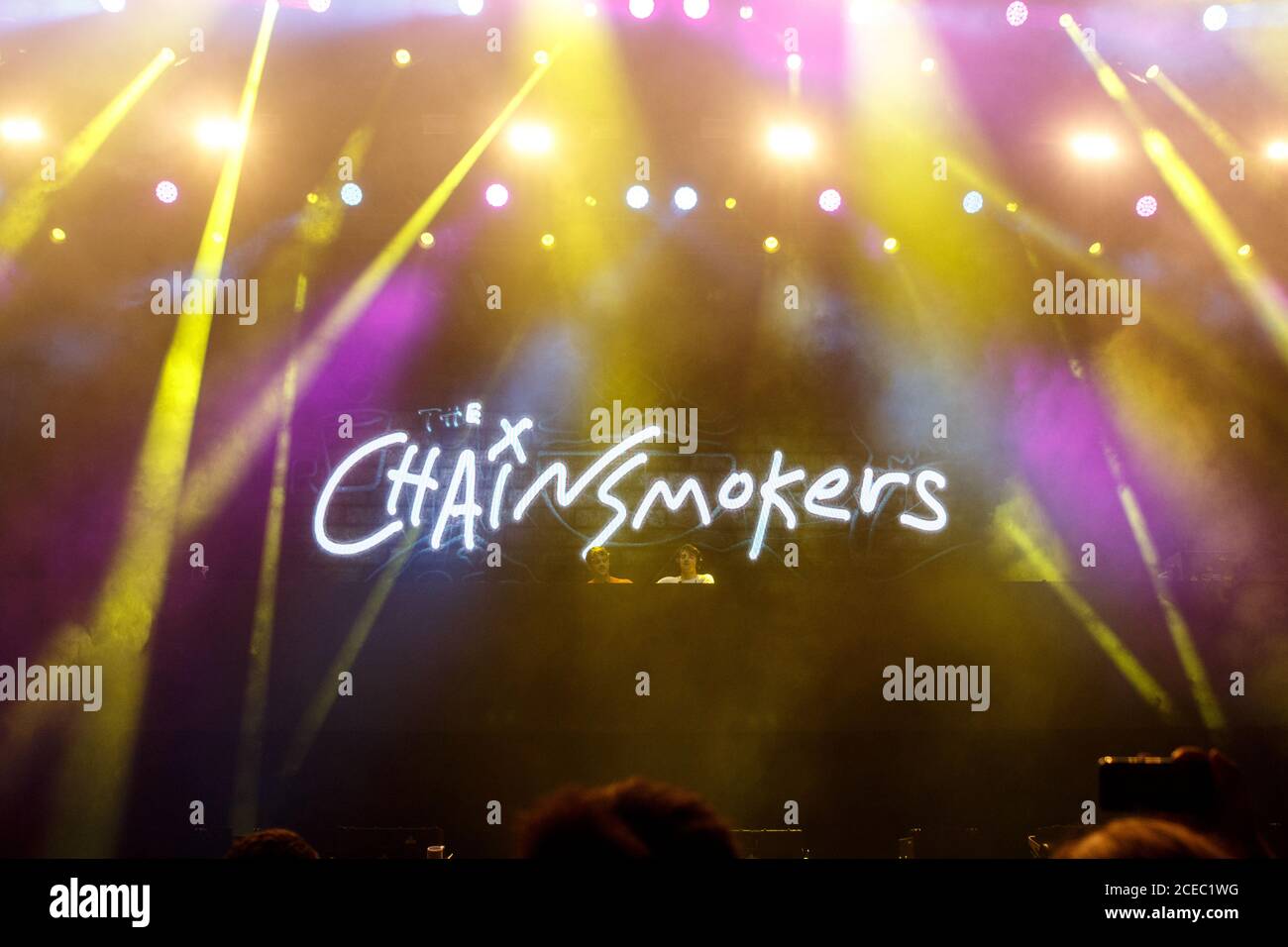 Portugal, MEO festival - 03. 08. 2018. View of bright spotlights on stage with glowing name of The Chainsmokers duet making show Stock Photo