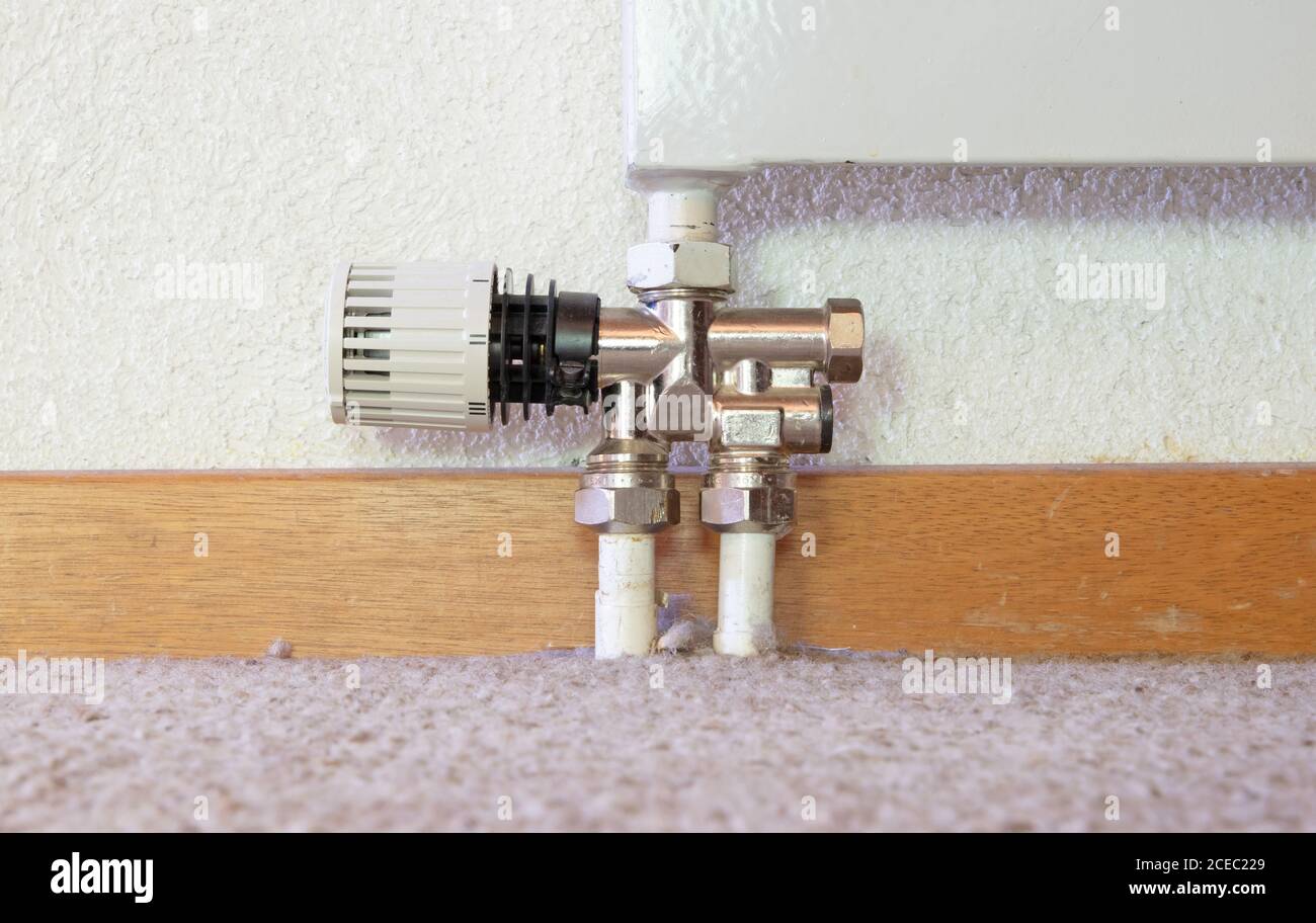 Heating radiator detail with adjusting knob, low to the ground Stock Photo Alamy