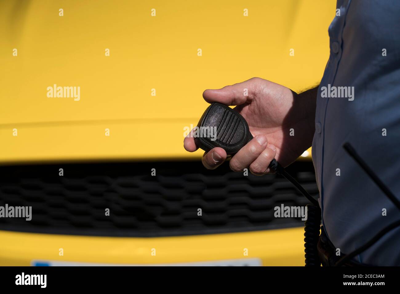 Crop policeman with portable radio set outside Stock Photo - Alamy
