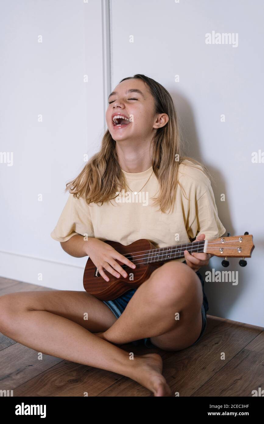 Young laughing Woman with ukulele Stock Photo