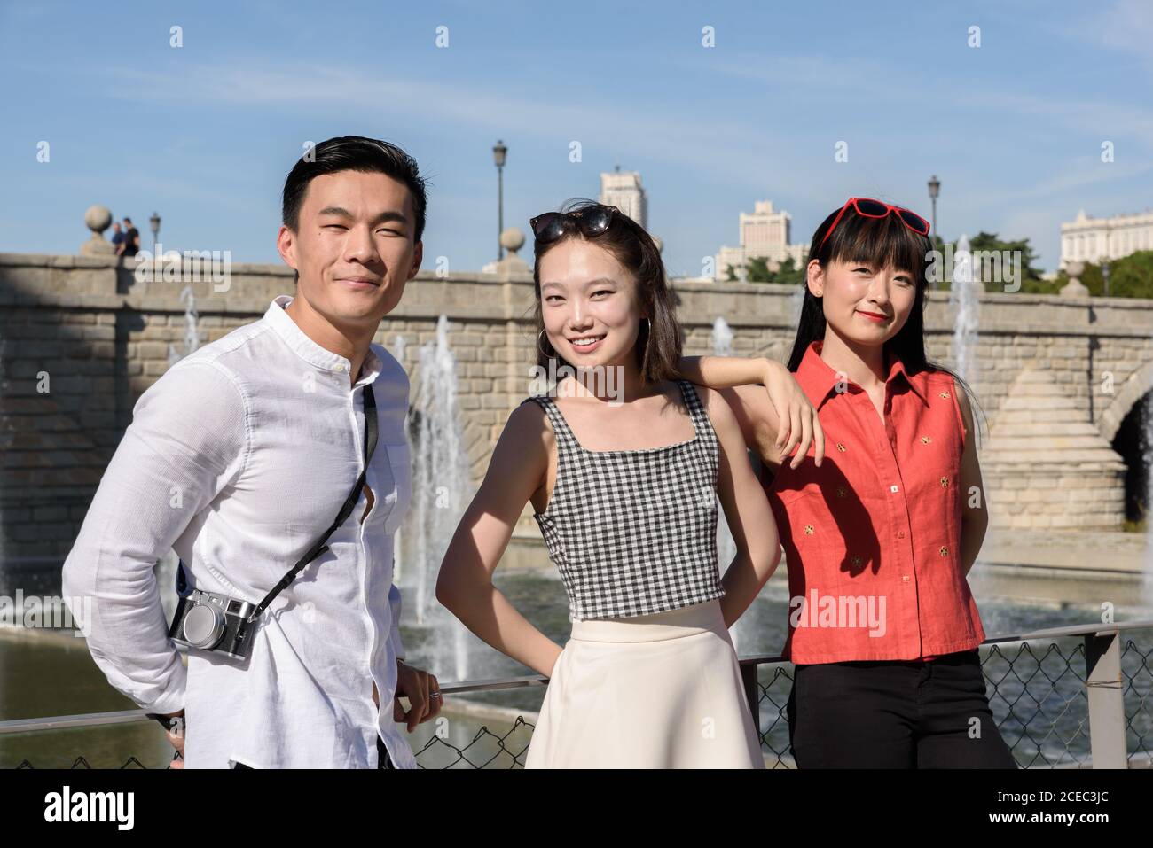 Asian people standing near fence in park Stock Photo - Alamy
