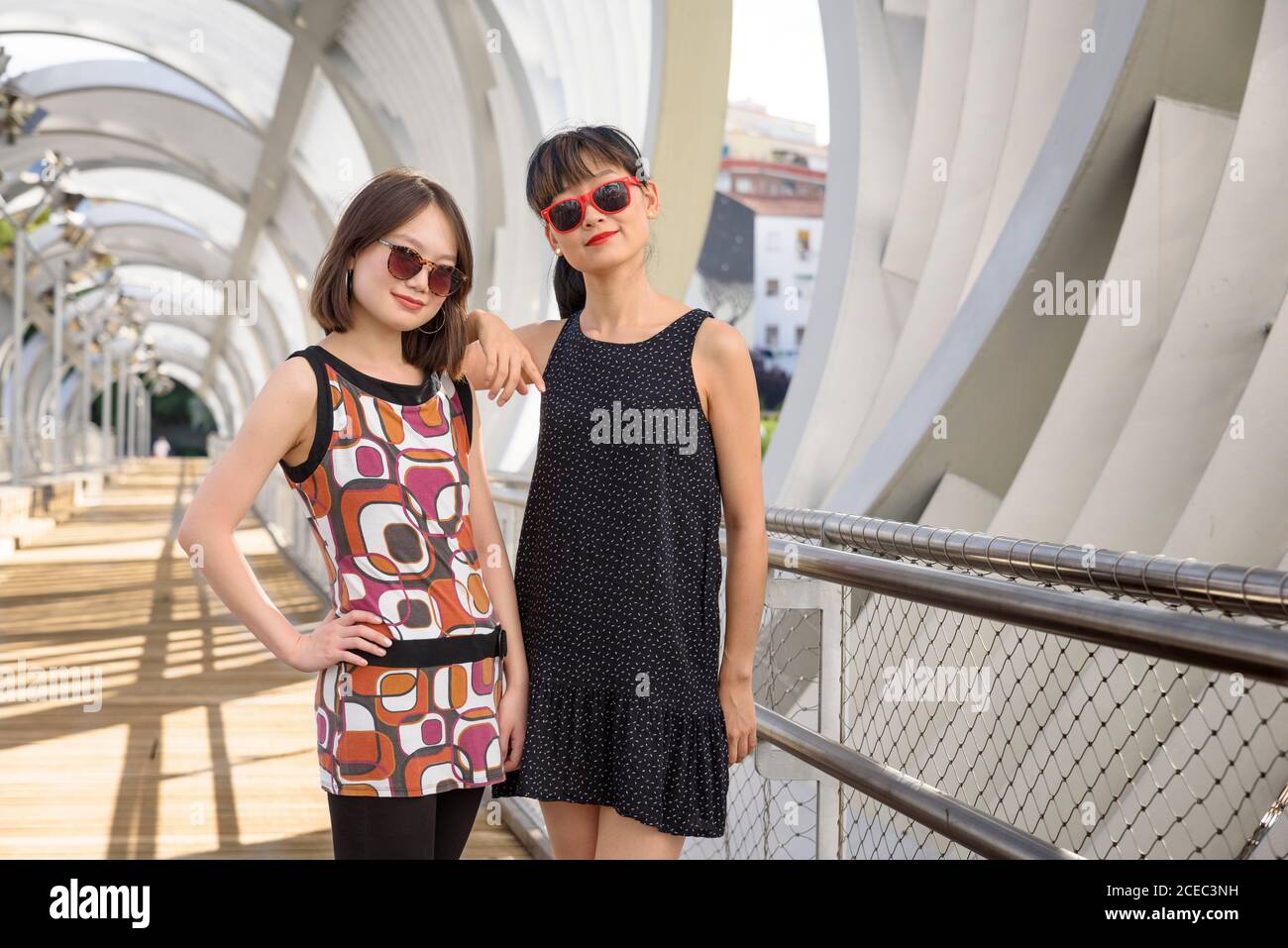 Asian ladies near modern structure Stock Photo