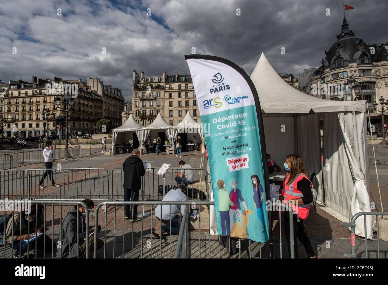 (200901) -- PARIS, Sept. 1, 2020 (Xinhua) -- People queue up at a temporary screening center for COVID-19 PCR tests in front of the city hall of Paris, France, Aug. 31, 2020. COVID-19 screening centers were set up in Paris on Monday, inviting Parisians to free tests after their return from vacation. These temporary centers will be operating in all of the French capital's arrondissements. Coronavirus infections have surged in France in recent weeks, particularly among young people, prompting the government to make mask-wearing mandatory outdoor and at workplace. (Photo by Aurelien Morissard Stock Photo
