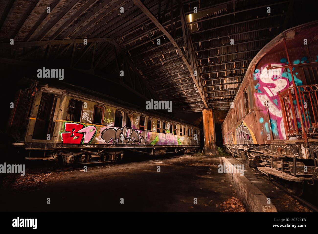 Old abandoned wagons with graffiti on surface standing in roofed depot Stock Photo