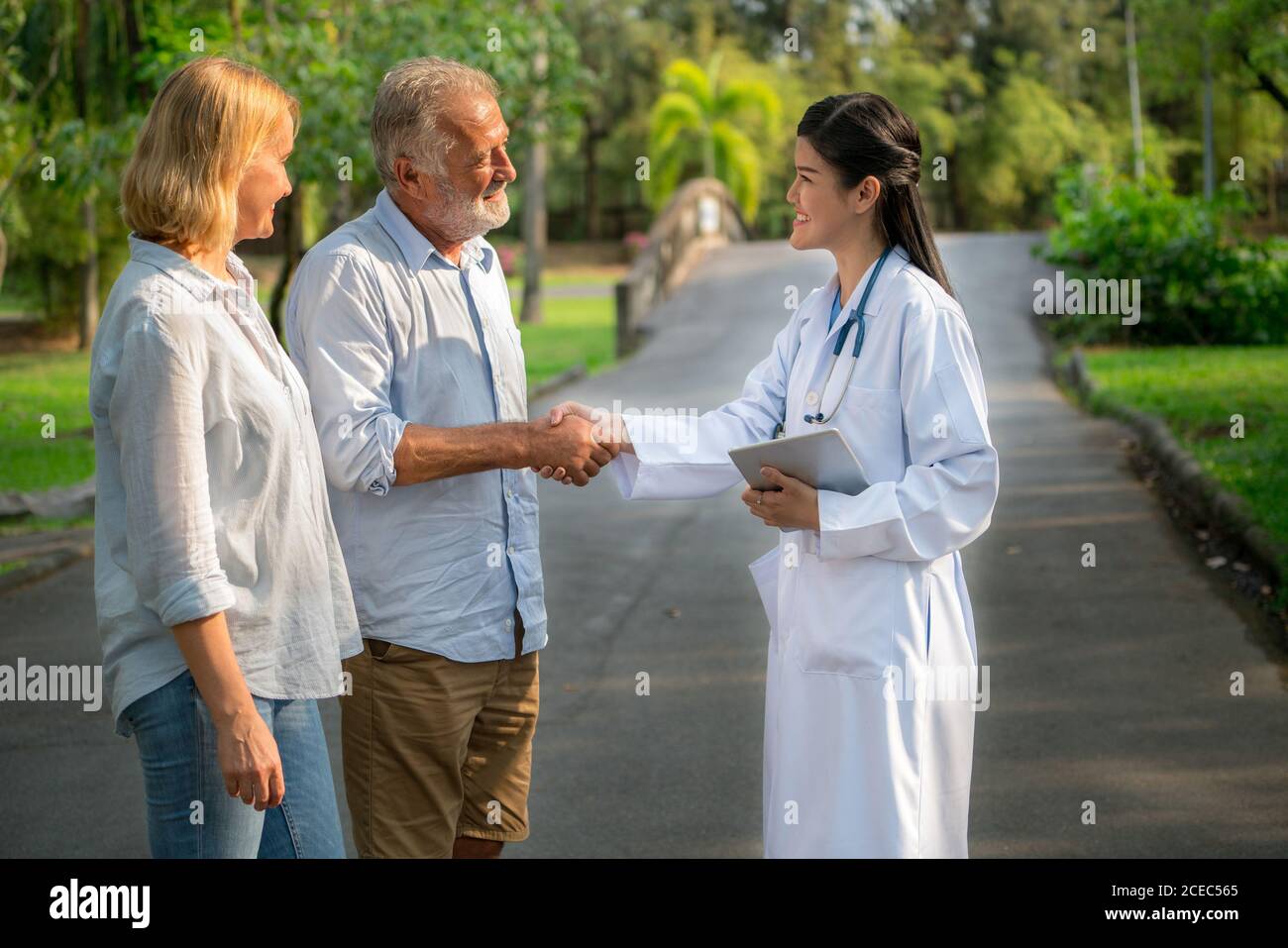 Senior couple talking to nurse or caregiver. Stock Photo