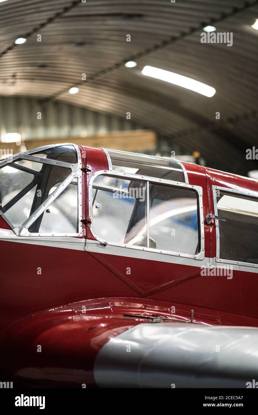 Red carcass of small vintage airplane standing in hangar Stock Photo