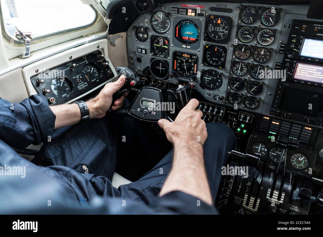 unrecognizable man in headset piloting plane?alone while sitting in ...