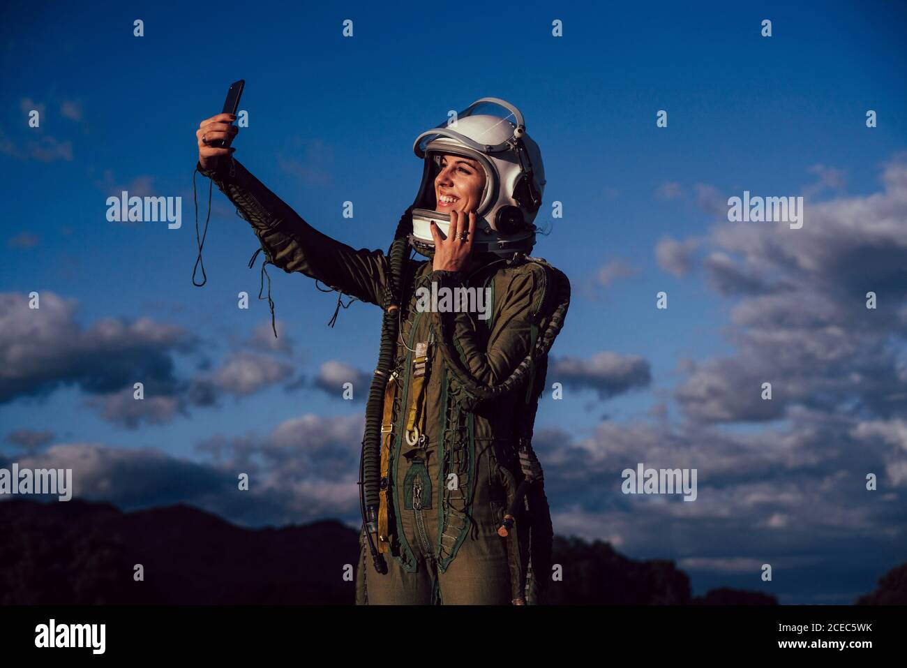 Beautiful female astronaut with mobile phone. Stock Photo