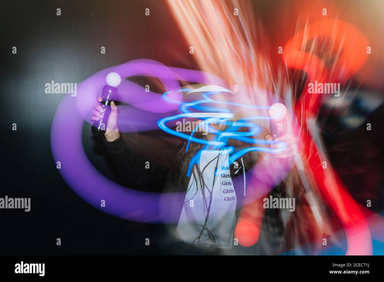 Woman playing VR game with controller Stock Photo