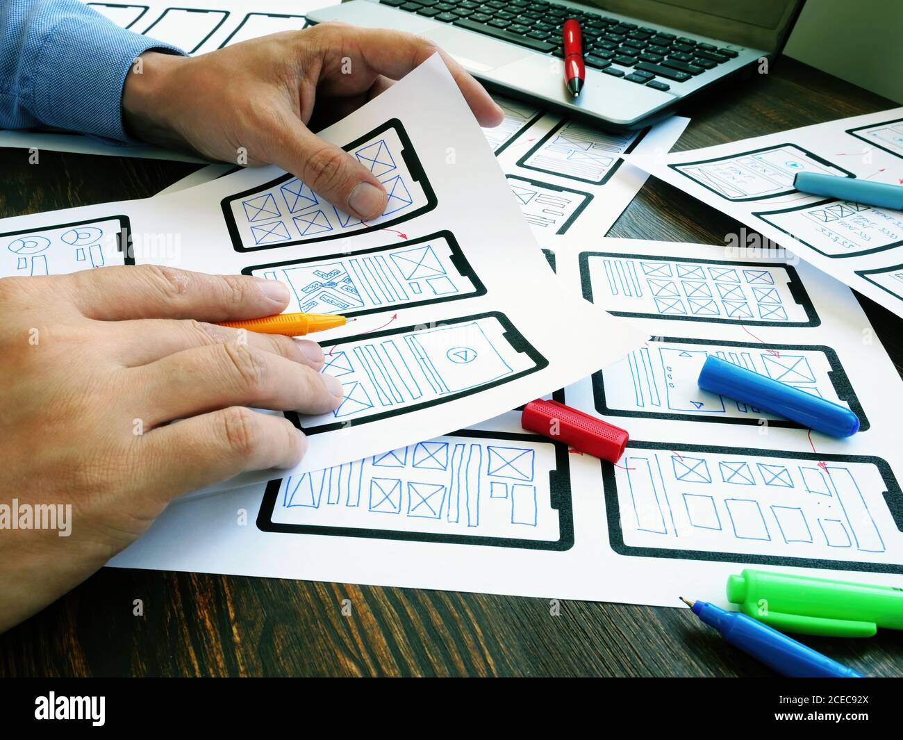 Ux ui designer working with web mobile app sketches. Stock Photo