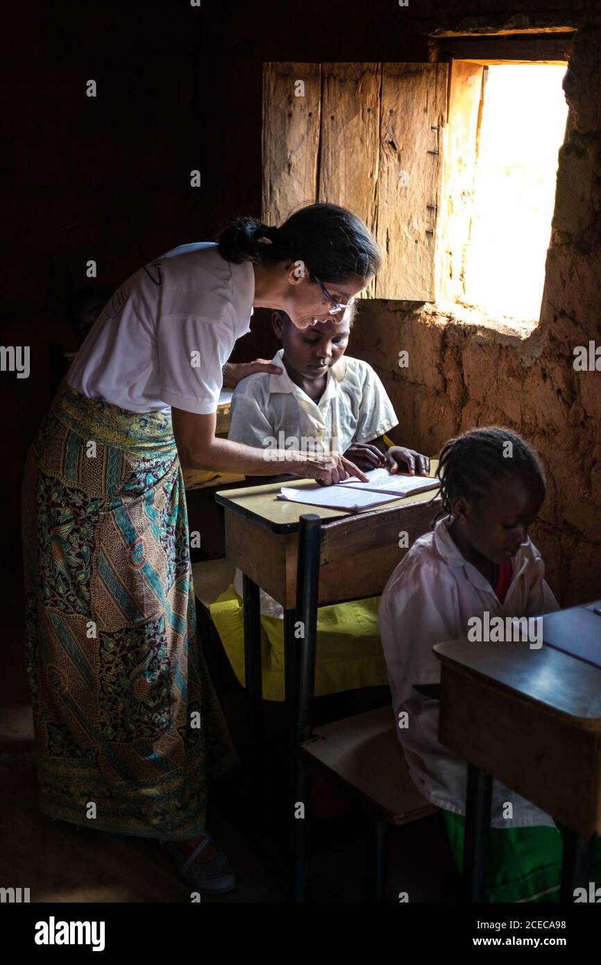 ANGOLA - AFRICA - APRIL 5, 2018 - Teacher Woman explaining to ethnic ...