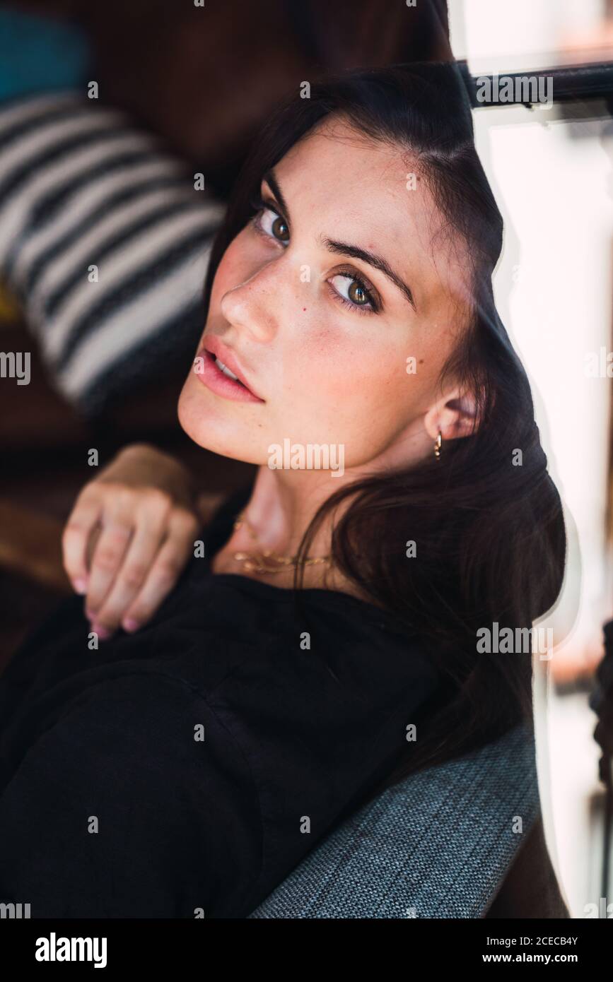 Young Woman sitting on chair Stock Photo - Alamy