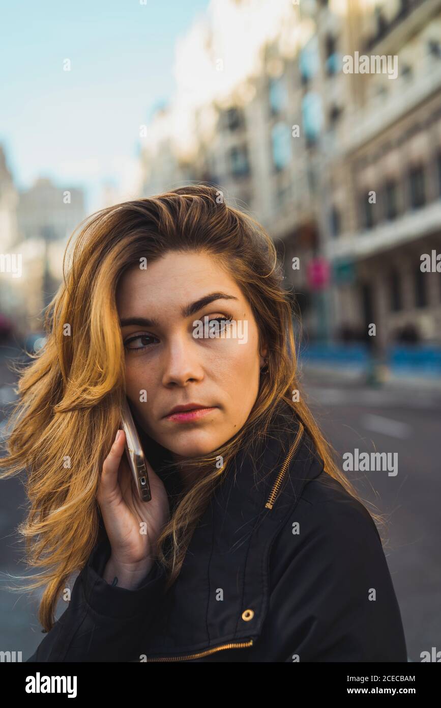 Woman using smartphone on road Stock Photo