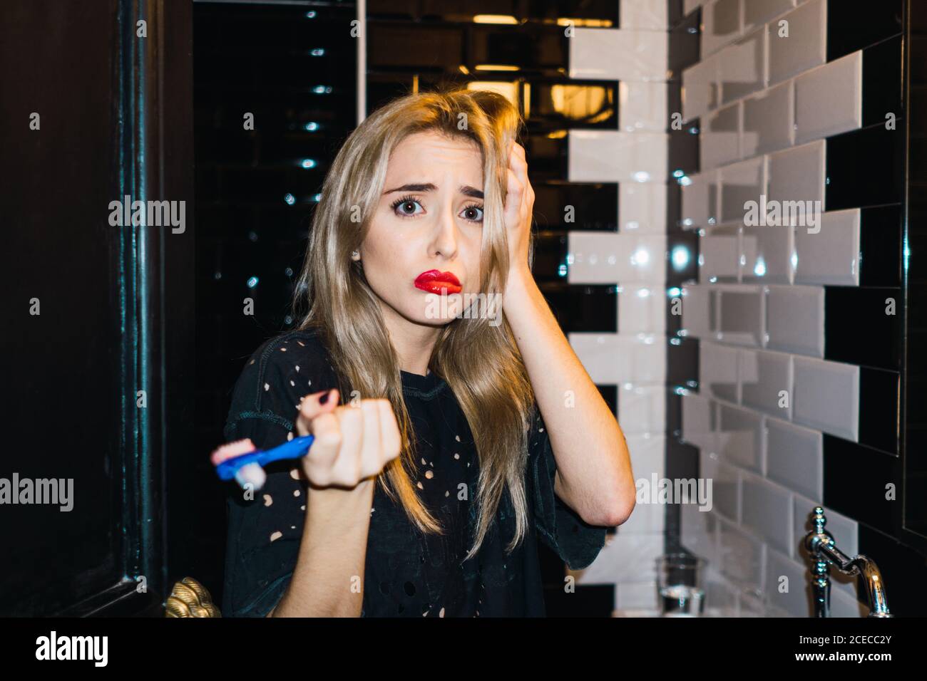 Blonde Woman brushing teeth Stock Photo