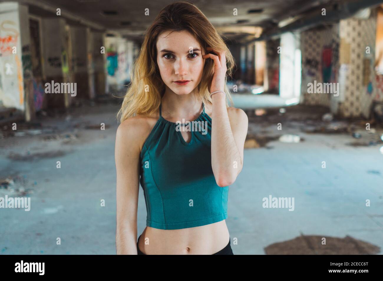 Skinny girl standing in decayed building Stock Photo