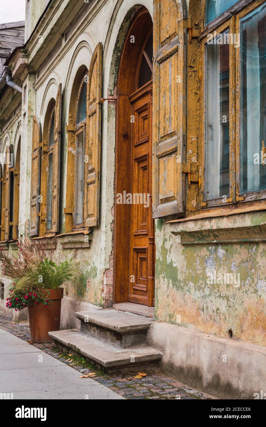 Stone pavement and small doorstep located near facade of aged grungy building on street of small town Stock Photo