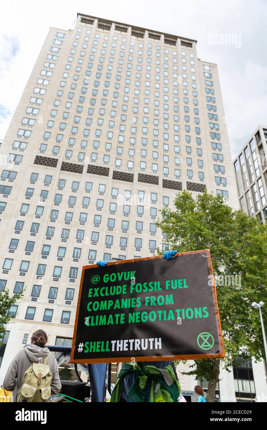 Protester holding up a sign during an Extinction Rebellion demonstration outside the Shell Centre, Jubilee Gardens, London, 28 August 2020 Stock Photo