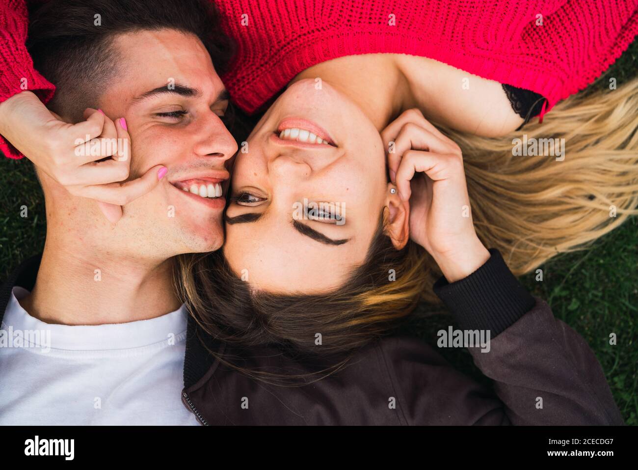 Happy loving couple posing on grass Stock Photo