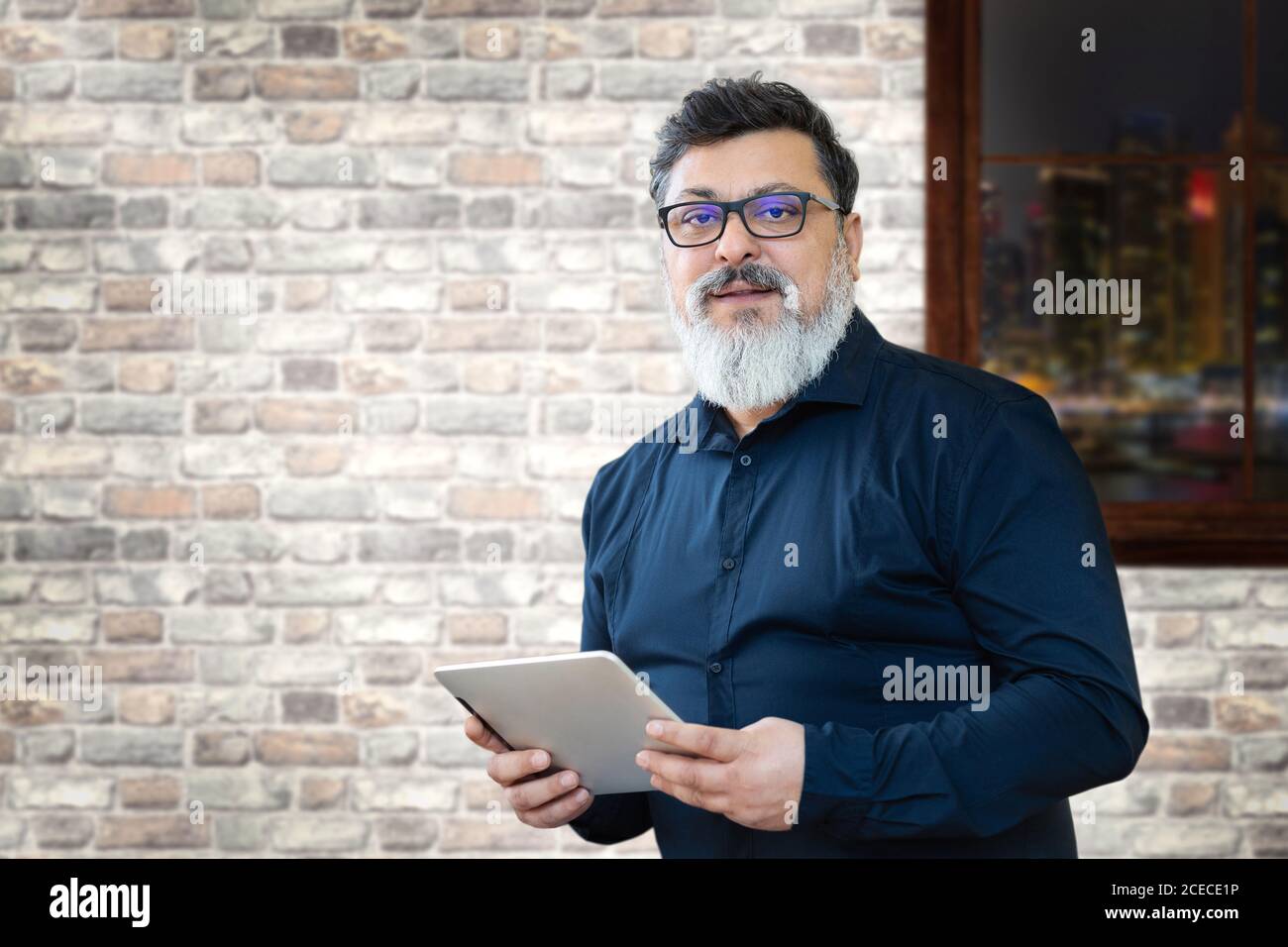 Mature mixed race business man in creative office Stock Photo
