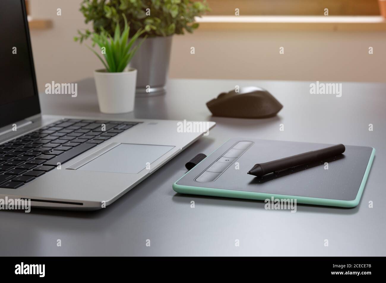 Drwaing tablet and laptop on a gray table Stock Photo