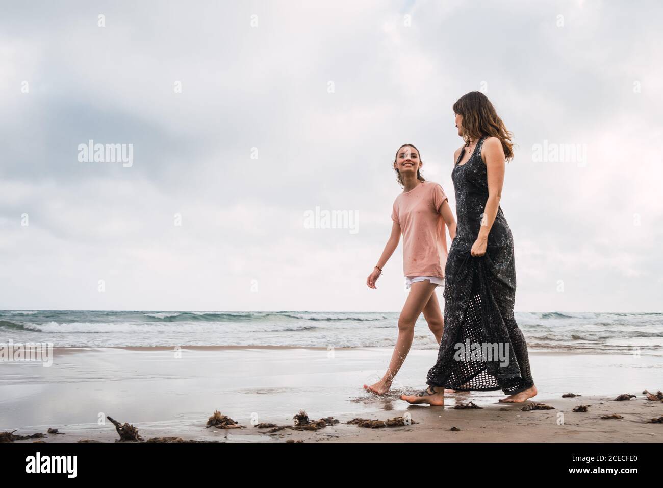 Two women walking beach hi-res stock photography and images - Alamy