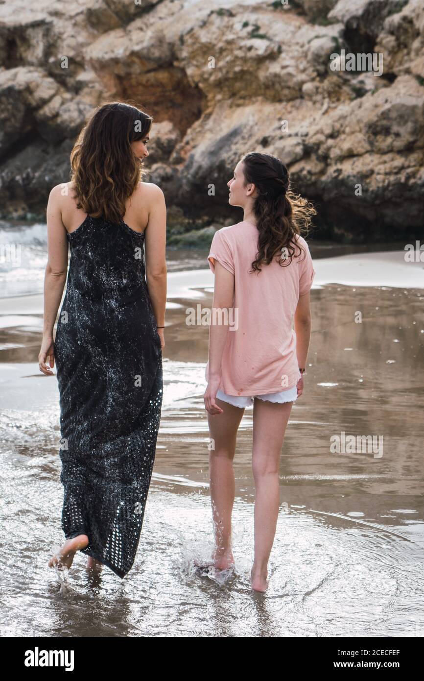 Two women walking beach hi-res stock photography and images - Alamy