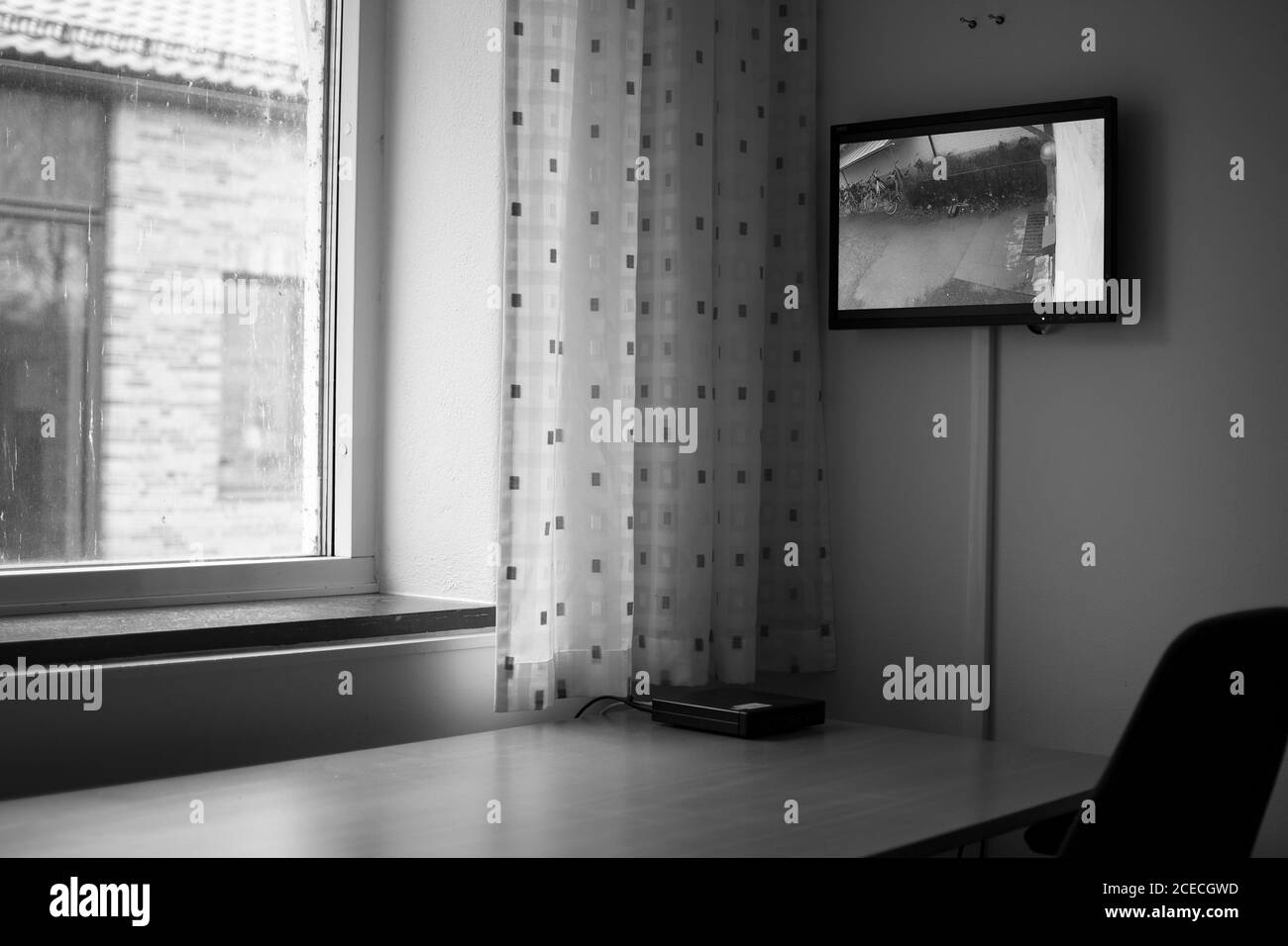 Empty office in a with a surveillance monitor in black and white Stock Photo