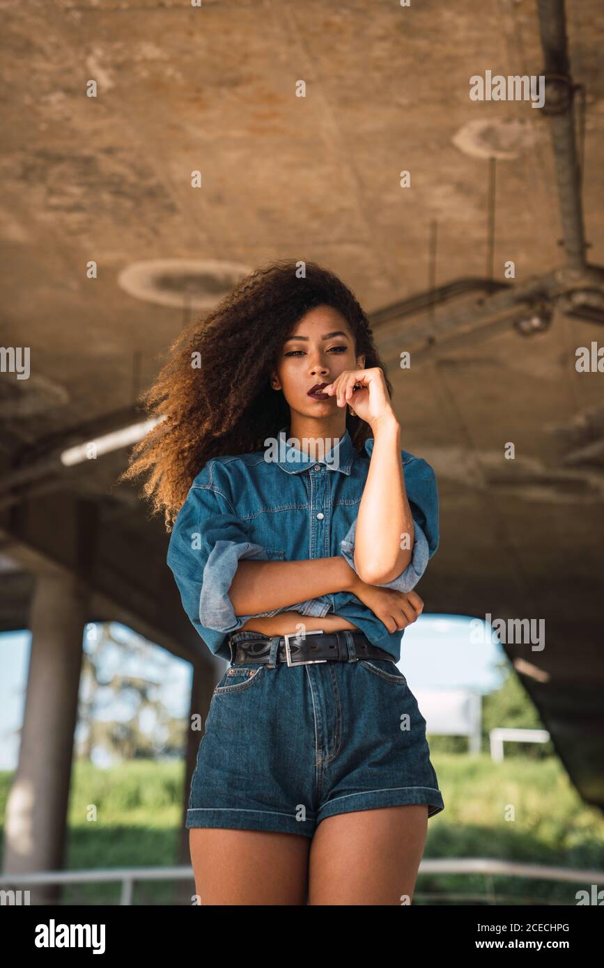 Young Woman standing under bridge Stock Photo