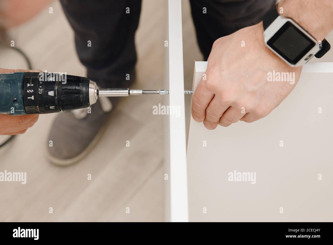 Installation and adjusting fixing kitchen cabinet door hinge adjustment Stock Photo