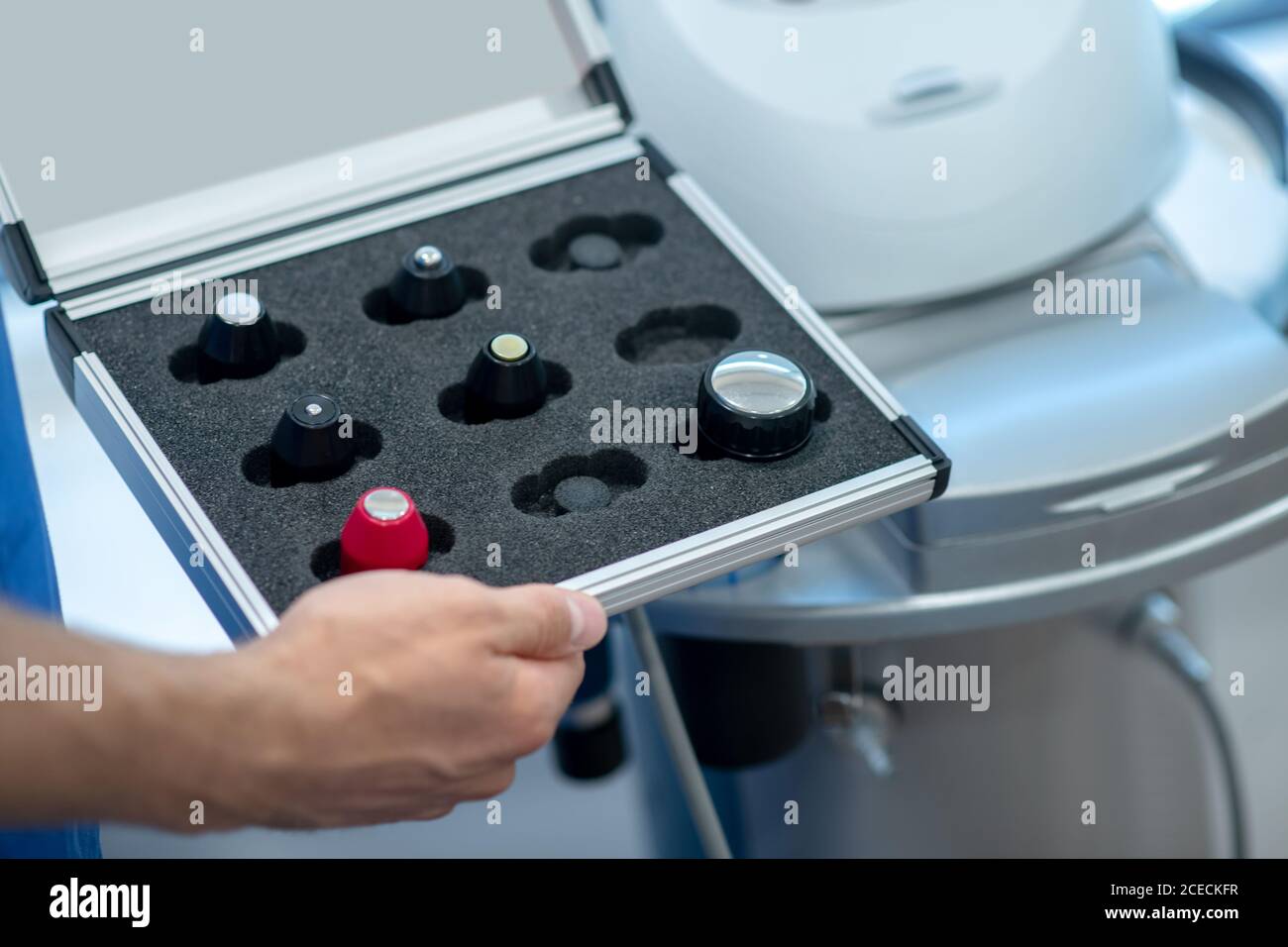 Close-up of male hands holding box with ultrasound machine changable heads Stock Photo