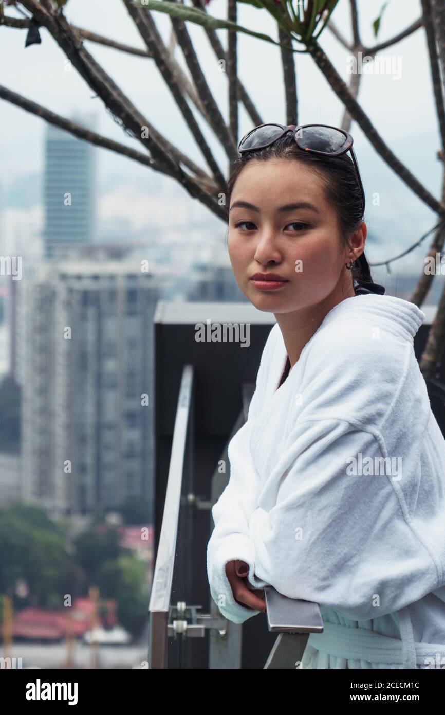 Woman in bathrobe at pool Stock Photo Alamy