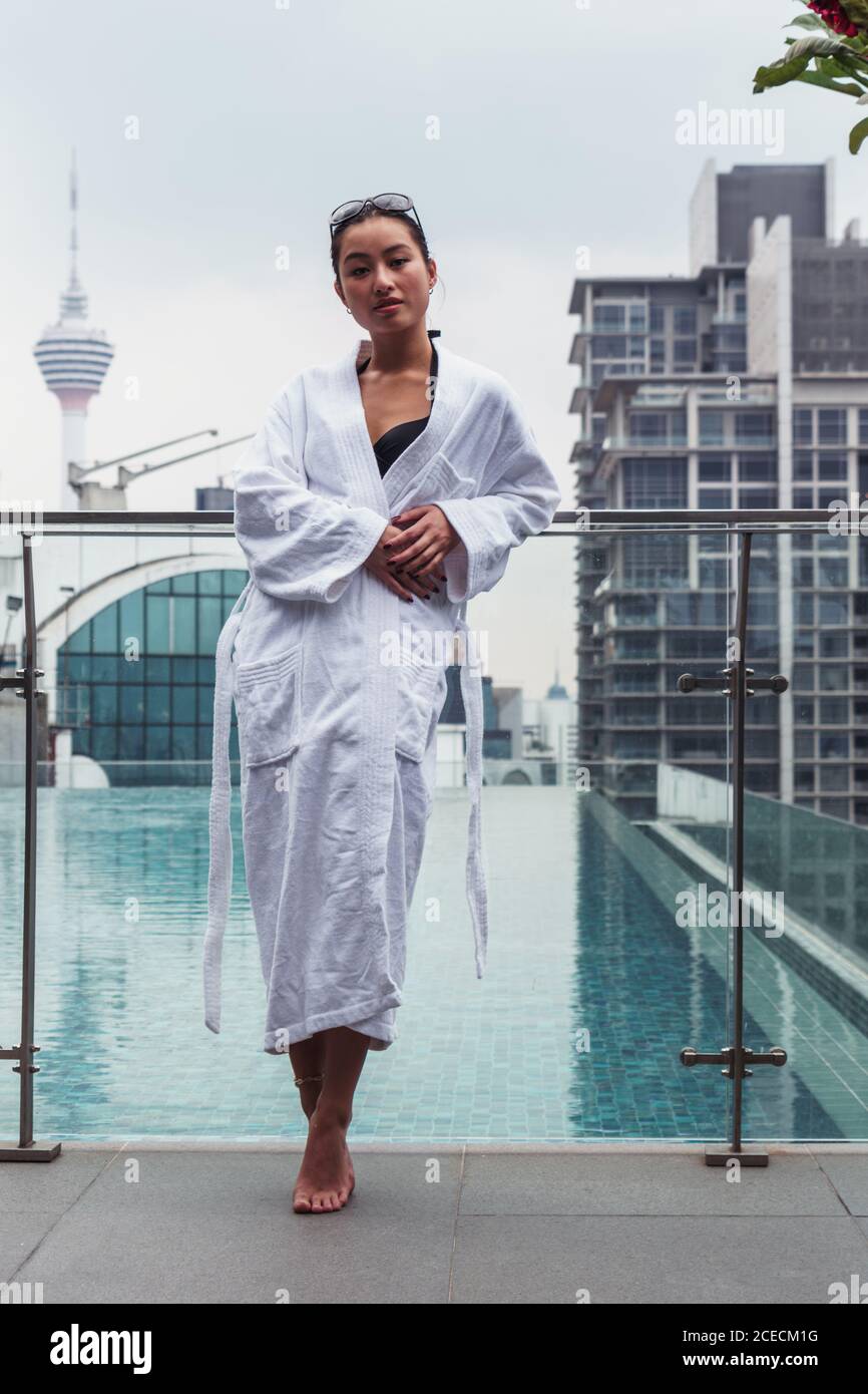 Woman in bathrobe at pool Stock Photo Alamy