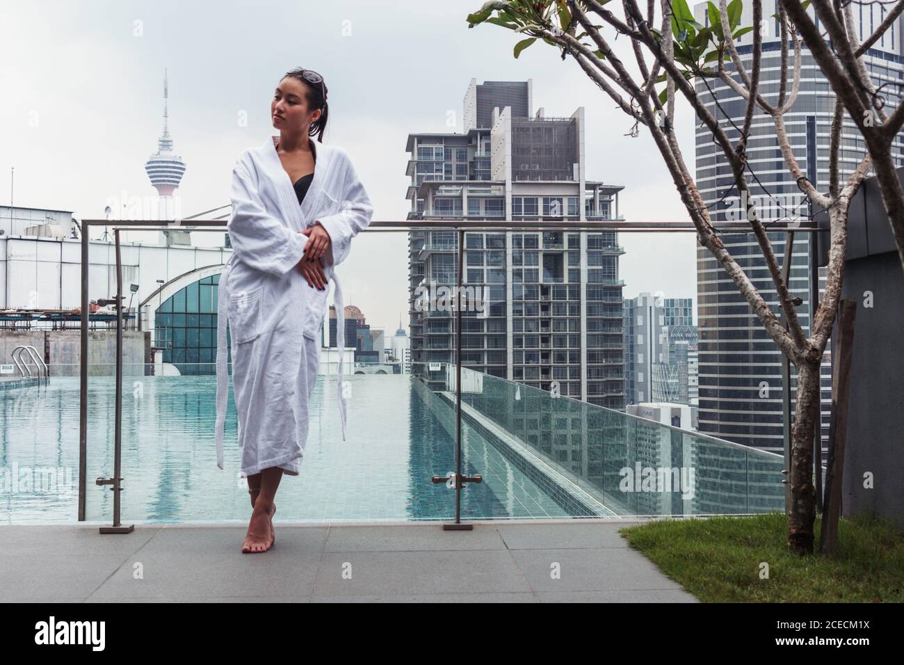 Woman in bathrobe at pool Stock Photo Alamy