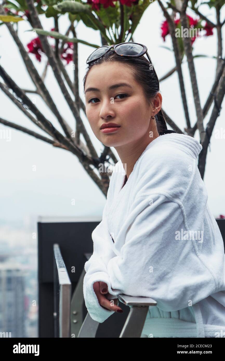 Woman in bathrobe at pool Stock Photo Alamy