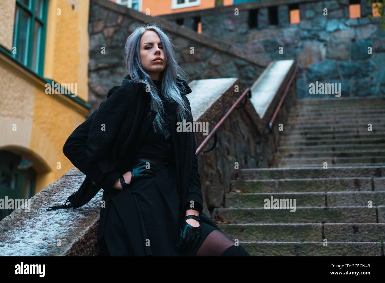 Person in black coat hi-res stock photography and images - Alamy