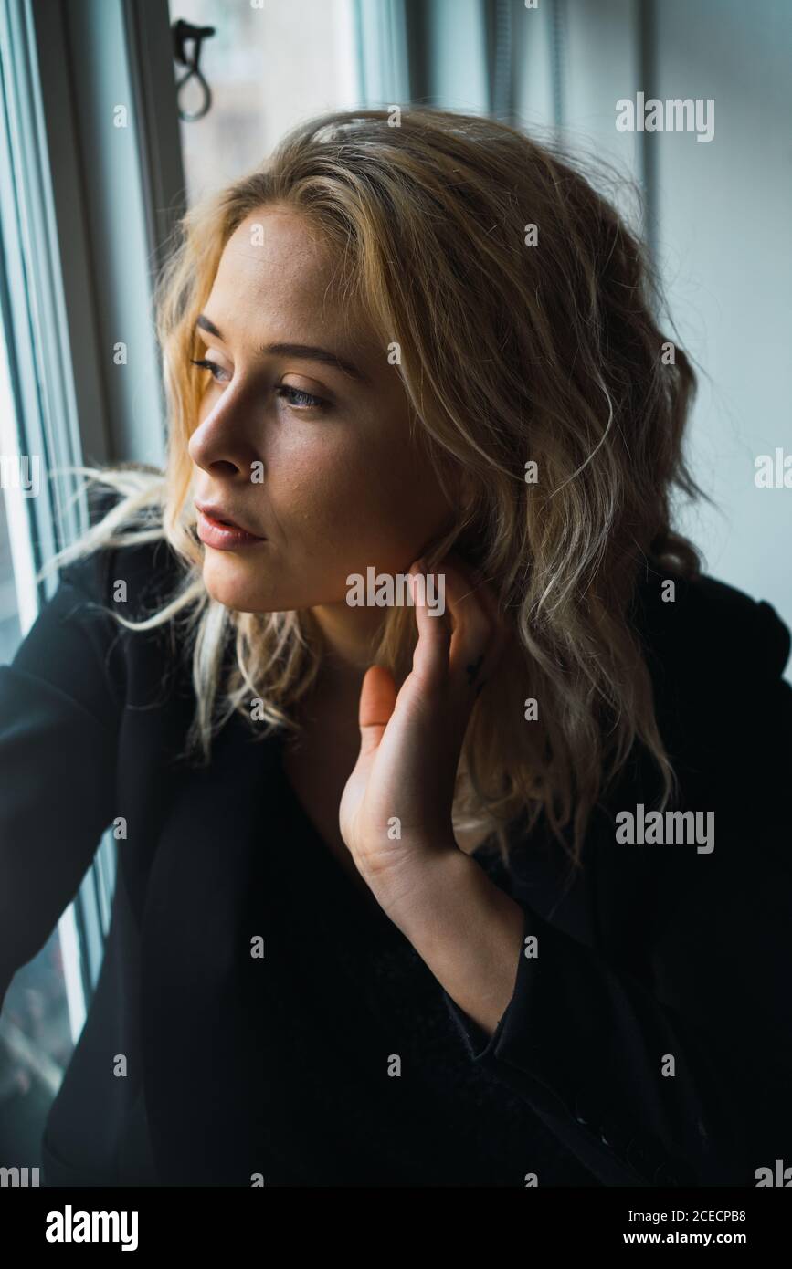 Romantic Woman posing on windowsill Stock Photo