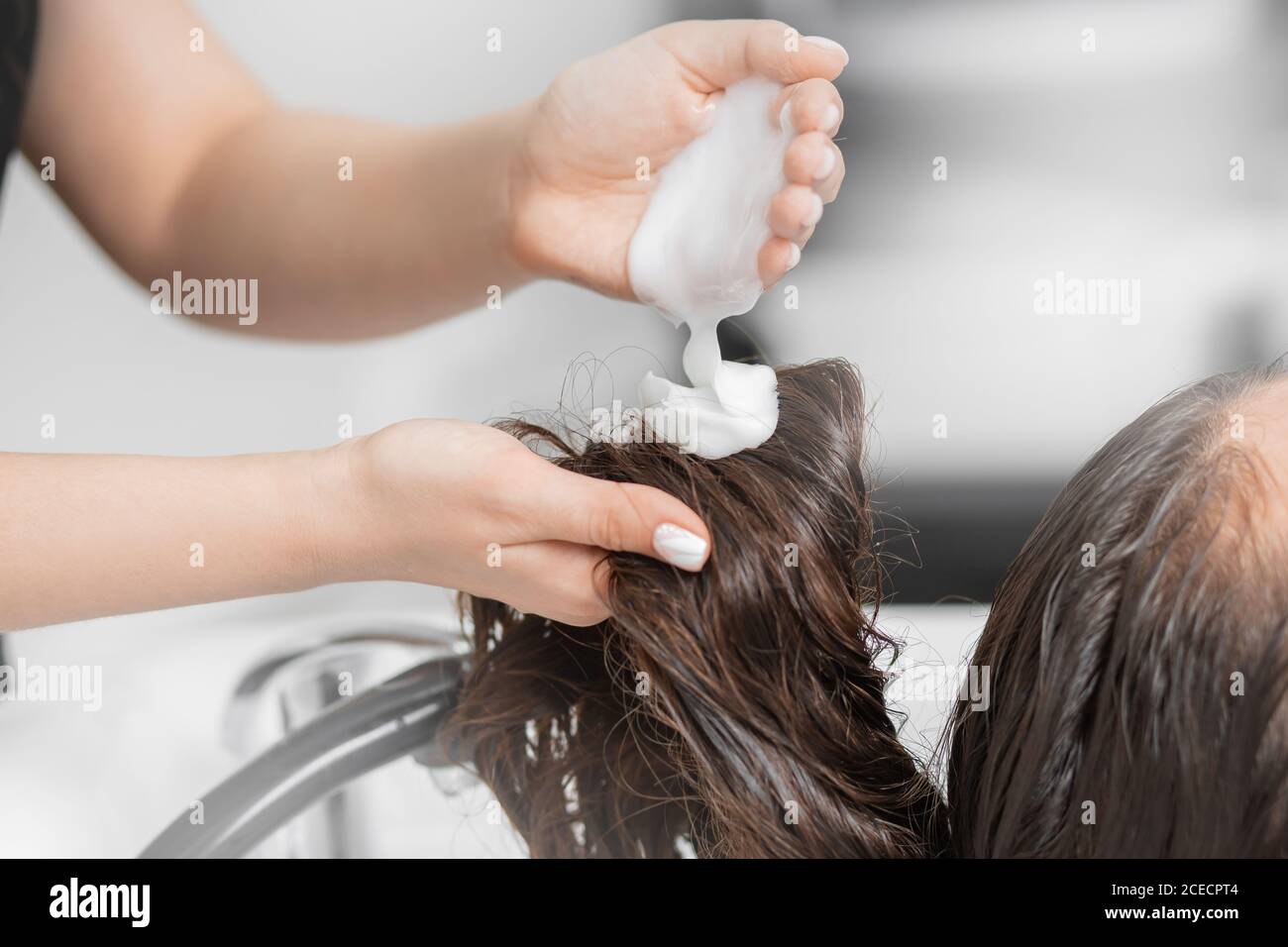 Hairdresser applies shampoo and hair conditioner client head. Concept spa  beauty salon Stock Photo - Alamy